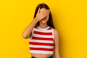 Young caucasian woman isolated on yellow background covers eyes with hands, smiles broadly waiting for a surprise.