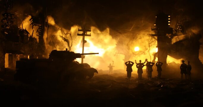 Military silhouettes fighting scene on war fog sky background. A German soldiers raised arms to surrender. Plastic toy soldiers with guns taking prisoner the enemy soldier. Selective focus