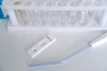 antigenic test cassette, glass test tubes with reagents, conducting a rapid test covid-19 in a...