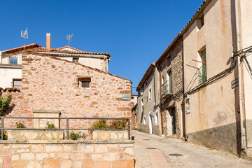 Obraz premium a street with traditional houses in Anguita town, province of Guadalajara, Castile La Mancha, Spain