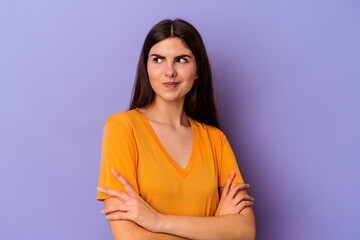 Young caucasian woman isolated on purple background dreaming of achieving goals and purposes