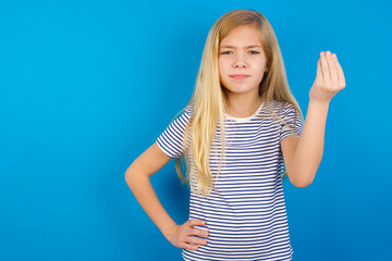 Fototapeta premium Caucasian kid girl wearing striped shirt ​against blue wall angry gesturing typical italian gesture with hand, looking to camera