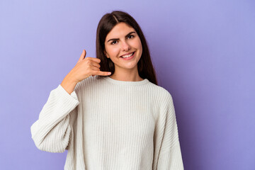 Young caucasian woman isolated on purple background showing a mobile phone call gesture with fingers.