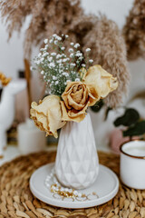 Still life of a bouquet of beautiful dried flowers in a vase. Interior vintage concept, cozy warm style