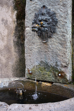 Ancient Stone Drinking Fountain Of Fresh Mountain Water With Lion And Fish Shaped