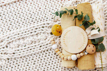 Newborn Background. baby muslin with a bow and bib. Empty wooden card. Gift for a newborn baby