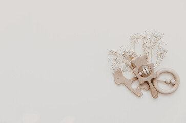 Flat lay Stylish wooden toy for kids on beige background. Gender neutral. Organic and natural toys. Eco friendly plastic free toys for toddler. Top view, card for text