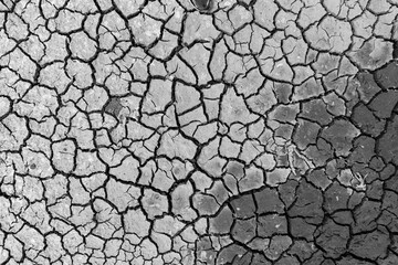 Mudflat cracked desert barren surface for natural background, layer, wallpaper, photo effect. Black and White Monochrome image of drought effects of global warming