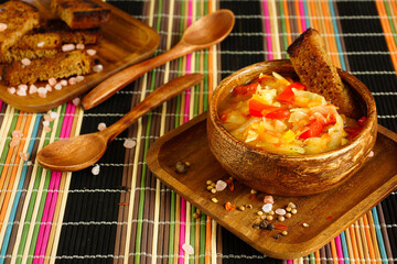 Thick cabbage soup in a wooden bowl. Traditional Russian soup with rye bread. Serving the dish - 431810495