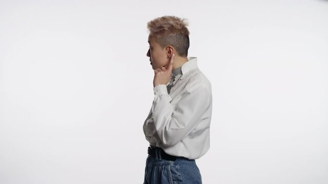 Young Asian person brushes off something they heard