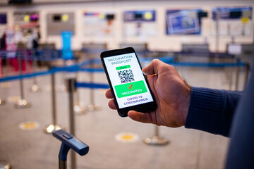 health Vaccine Passport for Coronavirus or Covid-19. Traveller Using Mobile Phone with Vaccination in Immune Status to Certificated International Traveling in Airport