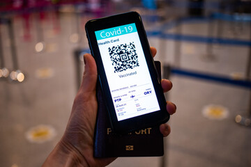 health Vaccine Passport for Coronavirus or Covid-19. Traveller Using Mobile Phone with Vaccination in Immune Status to Certificated International Traveling in Airport