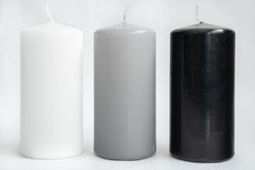 stylish candles black, gray and white on a white background