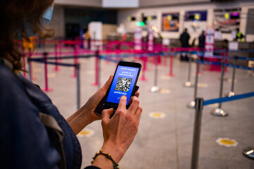 health Vaccine Passport for Coronavirus or Covid-19. Traveller Using Mobile Phone with Vaccination in Immune Status to Certificated International Traveling in Airport