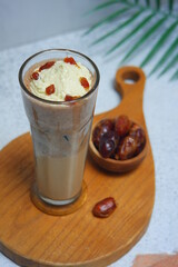a glass of dates frappe in white background