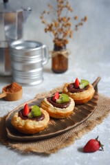 a plate of chocolate egg tart on the table