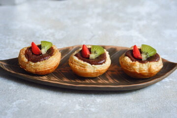 chocolate egg tart with fruits in a plate