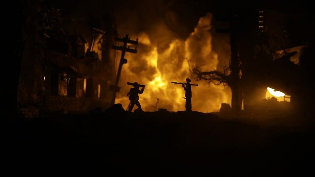 Military soldiers silhouettes with bazooka and rpg. War Concept. Military silhouettes fighting scene on war fog sky background, Mojahed with rpg and us soldier with bazooka at sunset. Attack scene