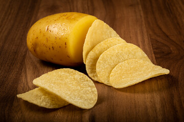 Delicious crispy potato chips on the table.