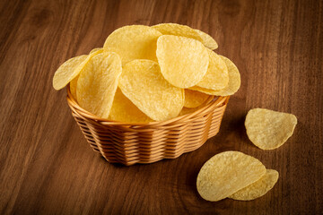 Delicious crispy potato chips on the table.