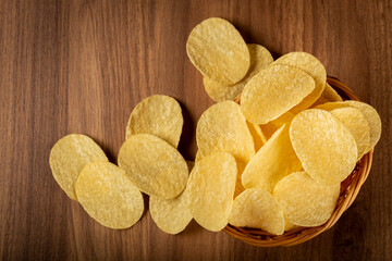Delicious crispy potato chips on the table.
