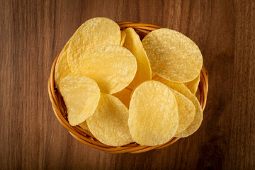 Delicious crispy potato chips on the table.
