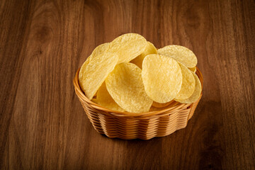 Delicious crispy potato chips on the table.