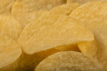 Delicious crispy potato chips on the table.