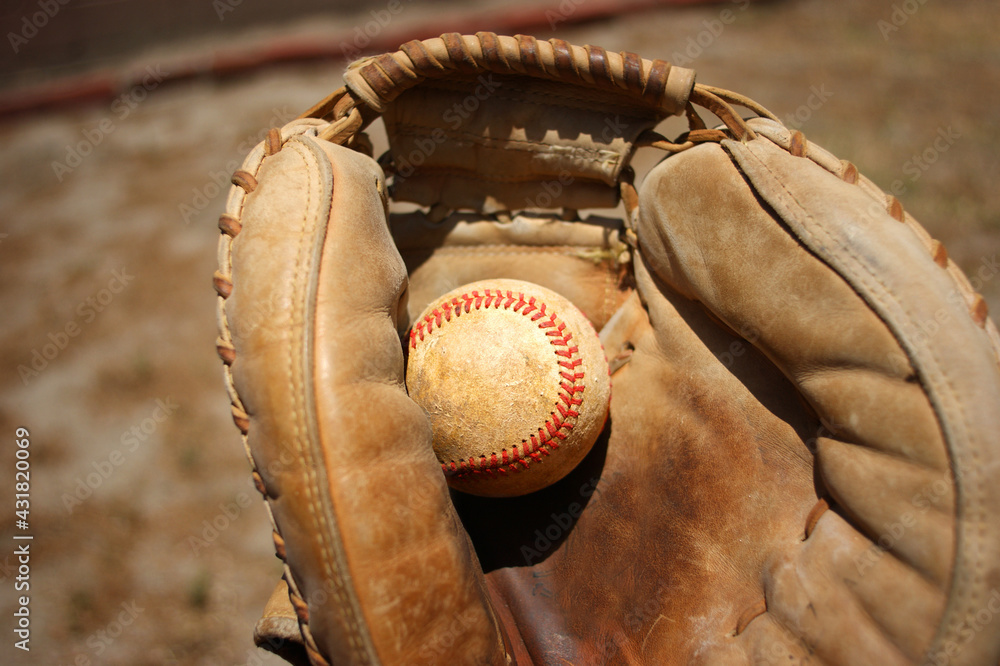 Wall mural Person catching baseball with leather glove