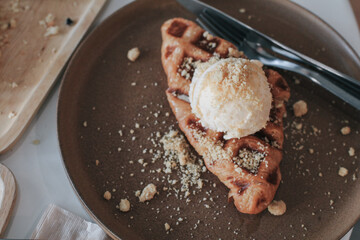 Fresh homemade waffles with ice cream and maple syrup. Delicious sweet dessert. Summer, open space