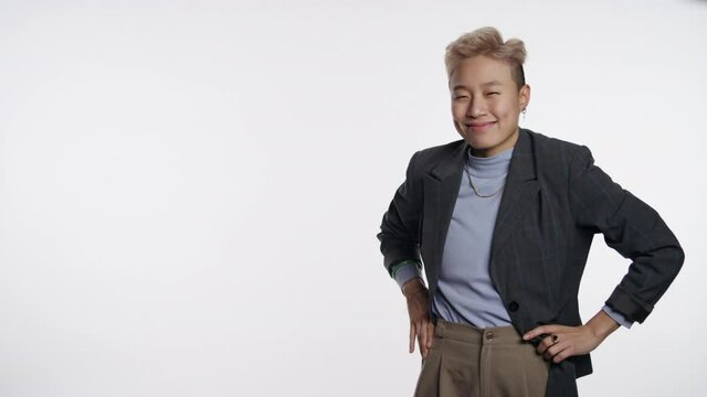 Warm welcoming Asian person motioning toward viewer on white