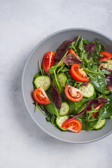 Healthy fresh salad of vegetable cucumber, tomato, spinach, arugula