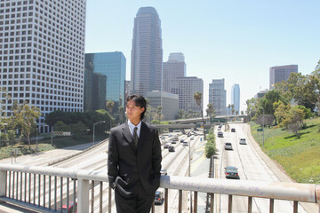 Fototapeta na wymiar Young Japanese businessman walking in the american business district 
