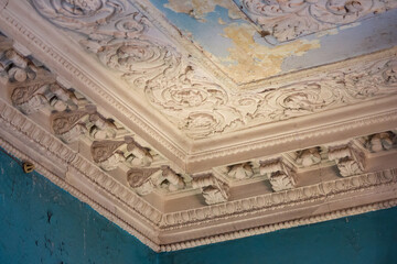 Fragment of stucco ceiling in an old building. Interior of an old house