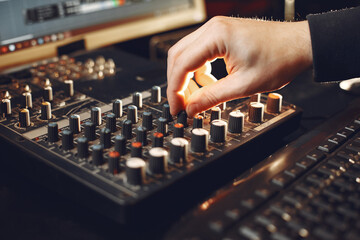 Man working in a studio with a sound recording equipment