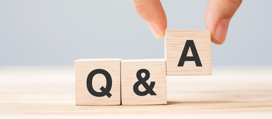 Hand holding Q and A word with wooden cube block. FAQ( frequency asked questions), Answer, Question  Ask, Information, Communication and Brainstorming Concepts - obrazy, fototapety, plakaty