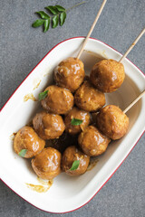 Delicious homemade popular Hong kong street food / Hong Kong Curry Fishball / Made from fresh Spanish Mackerel fish paste, formed into round fishball, deep fried, cooked in thick curry gravy