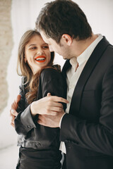 Portrait of young couple in love posing at studio