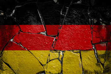 National flag of Germany. depicting in paint colors on an old stone wall. Flag  banner on broken  wall background.