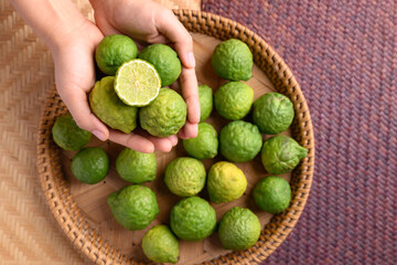 Fresh bergamot fruit holding by woman hand, Food ingredients and extract used for medicine, tea, perfumes and cosmetics