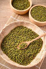 Mung bean seeds in wooden spoon and bamboo basket, Food ingredients in Asian cuisine and produce mung bean sprout