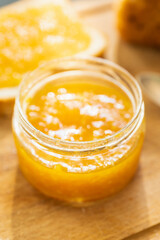 Jar with freshly making citrus jam. Selective focus. Shallow depth of field.