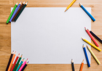 Colored pencils on a sheet of white paper. Selective focus. Backgrounds and textures.