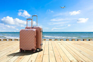 Travel suitcase on wood floor by the sea,travel concept. - obrazy, fototapety, plakaty