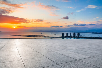 Empty square floor and modern city skyline with sea in Hainan.