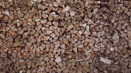 Wall of stacked pine wood logs as background. Pile of wooden logs stacked together on top of each other. Wall of stacked wood logs. Close-up Stack of firewood . Logs cuts prepared for fireplace.