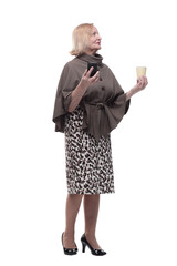 attractive mature woman with smartphone and coffee to take away.