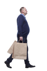 in full growth. casual mature man with shopping bags.