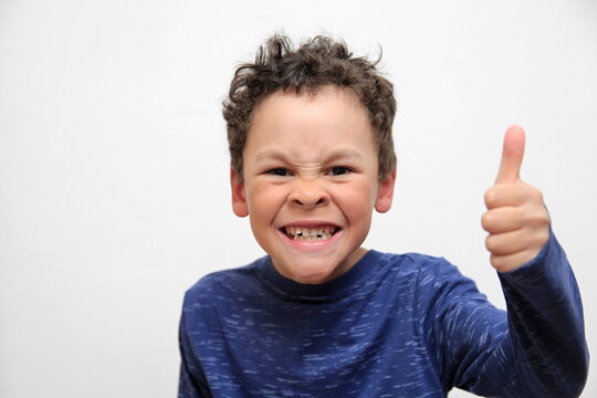 boy with thumbs up gesture on white background stock photo