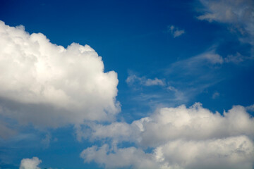 Naklejka na ściany i meble White clouds in a clear blue sky.